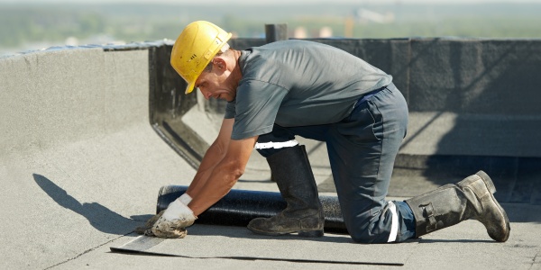 installing tape on roofing material